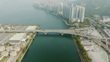 Hong-Kong-modern-asiatic-metropolis-aerial-view-of-bridge-over-the-ocean-connecting-the-main-city-downtown,-aerial-footage-of-Chinese-city