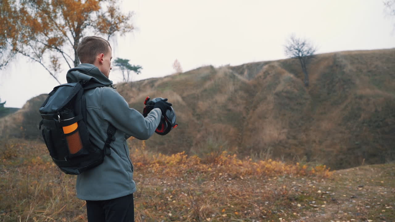 Male Cyclist Puts On His Helmet And Rides On The Mountain Bike