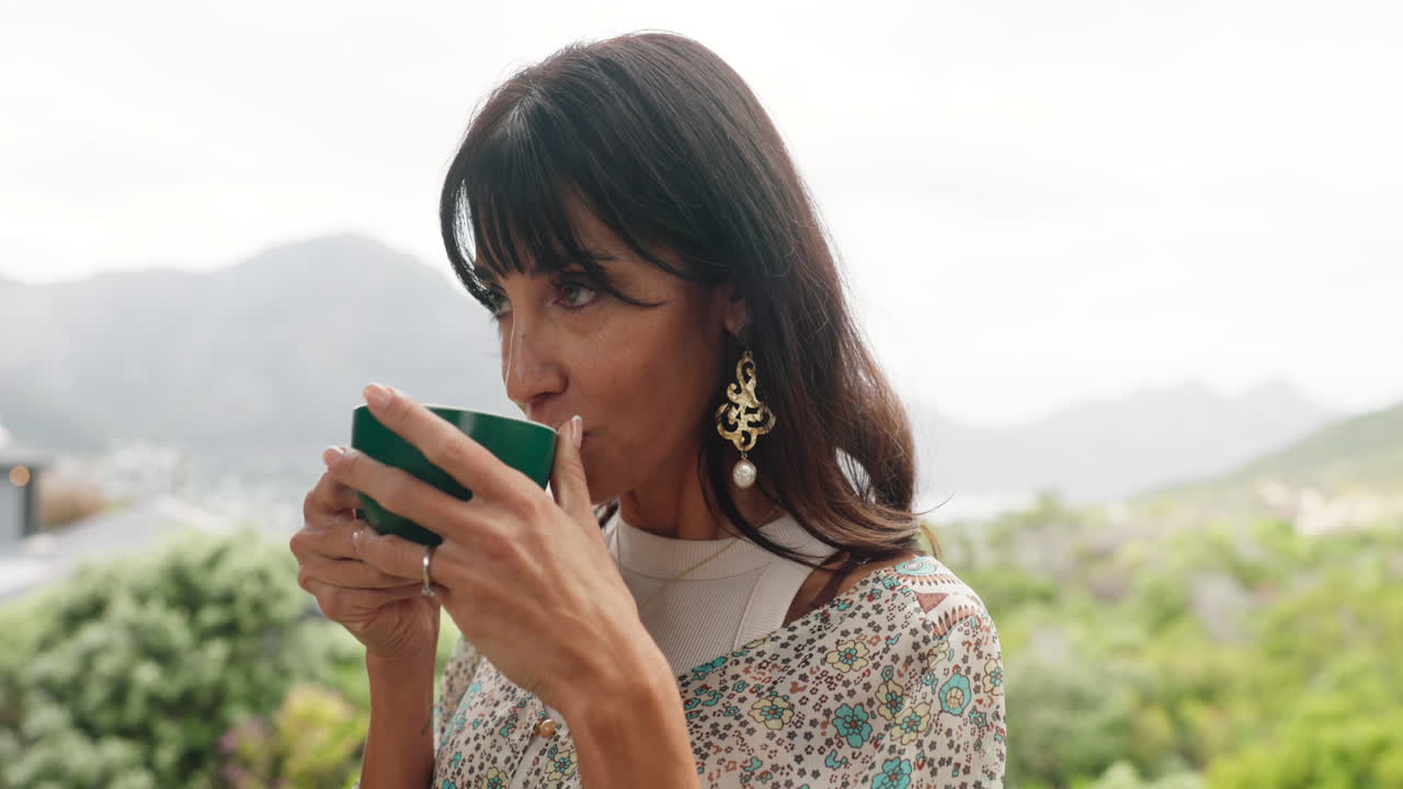 Relaxed Woman Sips Coffee Outdoors with Mountain View