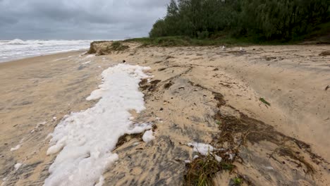 foamy waves and debris cover broadbeach as cyclone alfred impacts the coastline, creating a dramatic and stormy atmosphere
