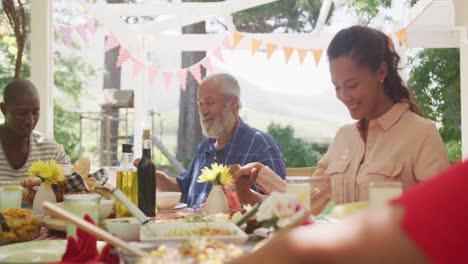 Multi-generation-African-American-family-spending-time-in-garden-together