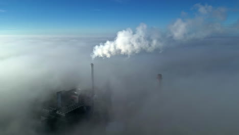 power plant in dense fog: aerial view
