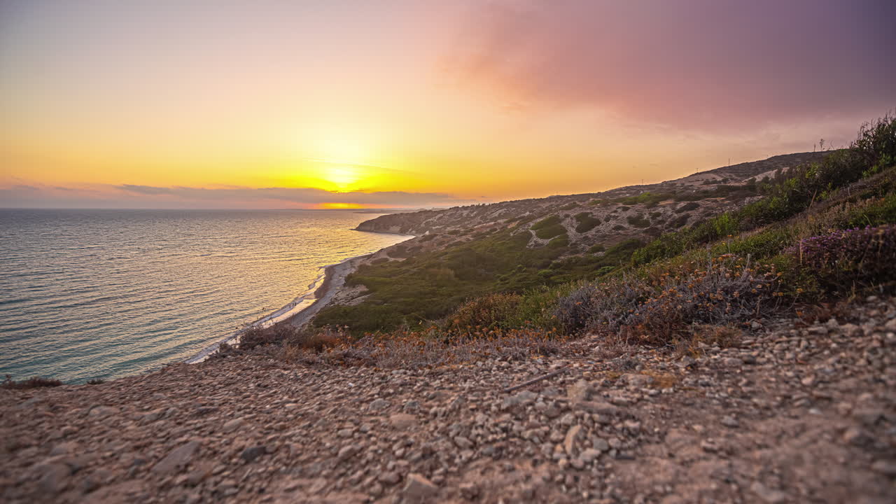Beautiful orange sunset at Aphrodite's Rock on the island of Cyprus