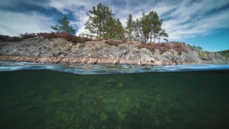 eine kleine felsige insel am fluss otra, norwegen