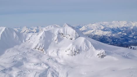stunning snowy winter mountain scenery, aerial on a sunny day