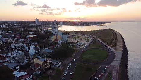 Aerial-view-of-seaside-city-and-sunset-in-Posadas,-Misiones,-Argentina