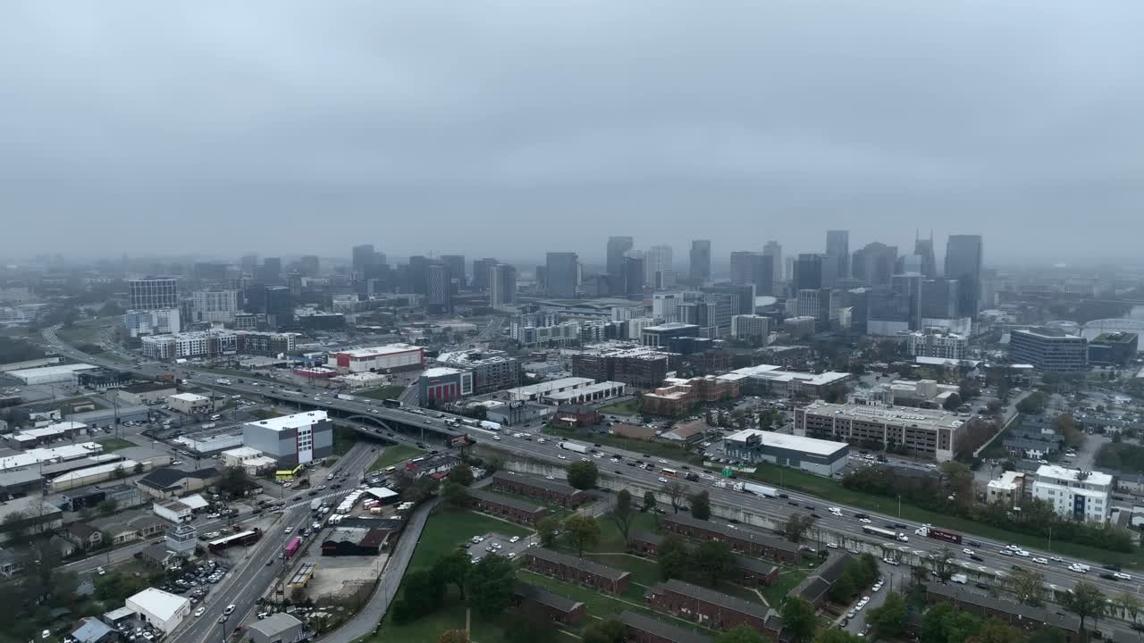 Drone footage orbiting downtown Nashville, Tennessee, on a gloomy overcast day in the fall.