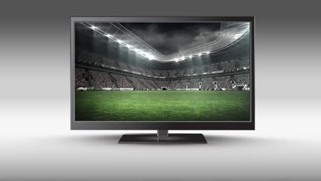 televisor de pantalla plana con un estadio de fútbol en su pantalla