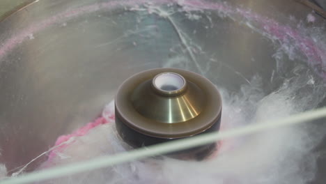 a closeup shot of a cotton candy machine making cotton candy