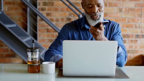 Senior-man-talking-on-mobile-phone-at-home-4k