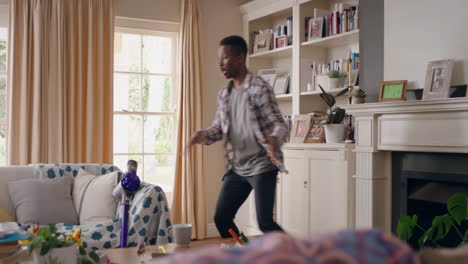 happy african american man dancing at home celebrating success having fun crazy dance in living room enjoying lifestyle freedom on weekend 4k