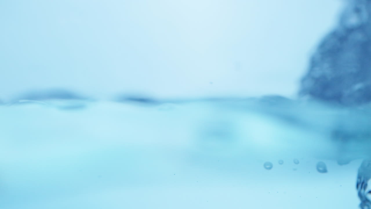 Elegant slow-motion display of rippling water, emphasizing the natural beauty and freshness of drinking water.