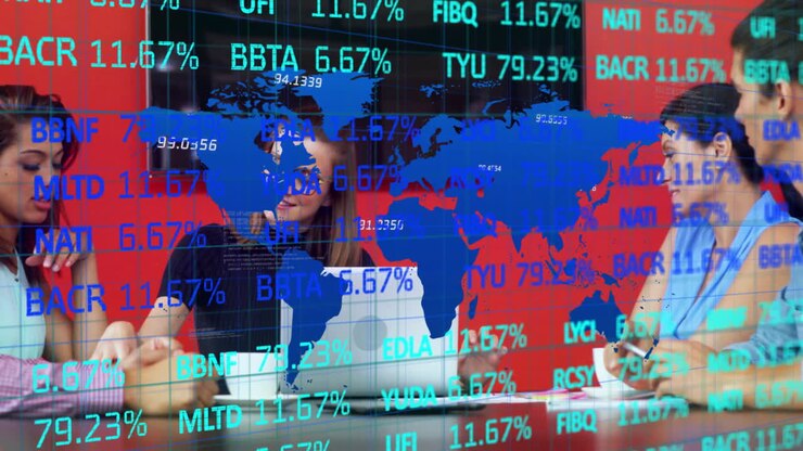 Overlaying world map and stock market data, business people working on laptops