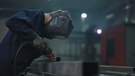 welder carries out welding of metal. welder in special mask connects metal parts at bright sparks. welder in special mask connects metal parts at bright sparks slow motion