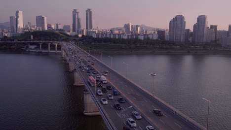 aerial view of traffic on a bridge in seoul at sunset