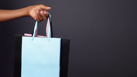 woman holding colorful shopping bags