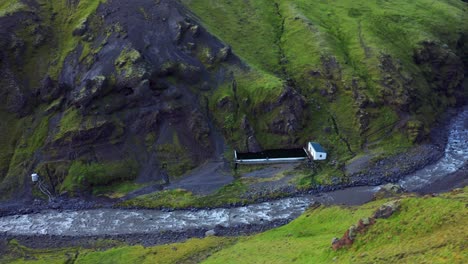 Aerial-View-Of-Seljavallalaug-Swimming-Pool-On-Foothill-Of-Mountain-In-Iceland