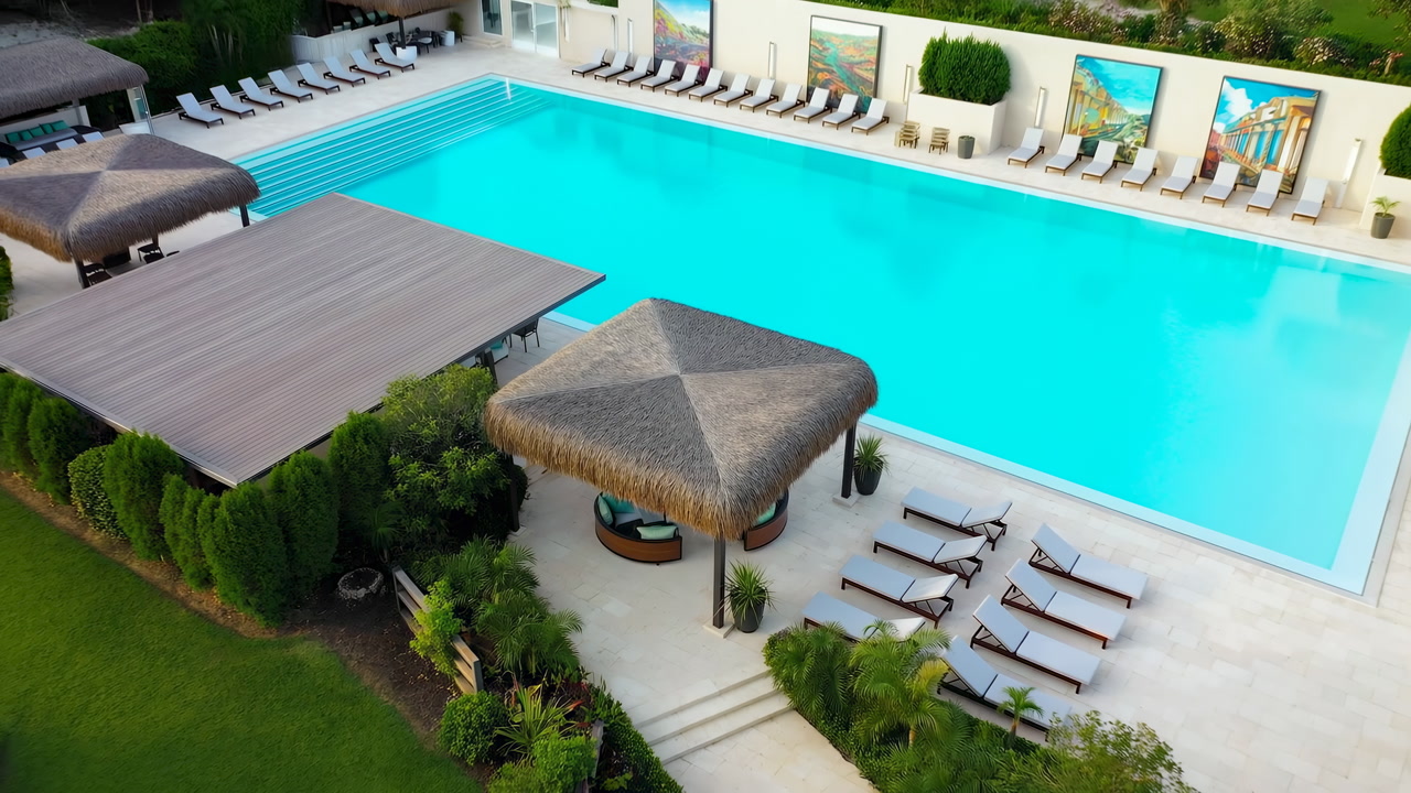 Aerial View Luxury Resort Pool Cabana Pristine Turquoise Water, Empty Sun Loungers, Thatched Roof Cabana,