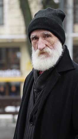 an elderly man with white beard wearing black hat reflecting on life and past experiences an elderly man distinguished by a striking white beard and a traditional black hat exudes wisdom and character