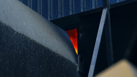 flashes of fire in the aperture between the elevator parts. burning fire for the drying of grain in the grain elevator for storage crop.
