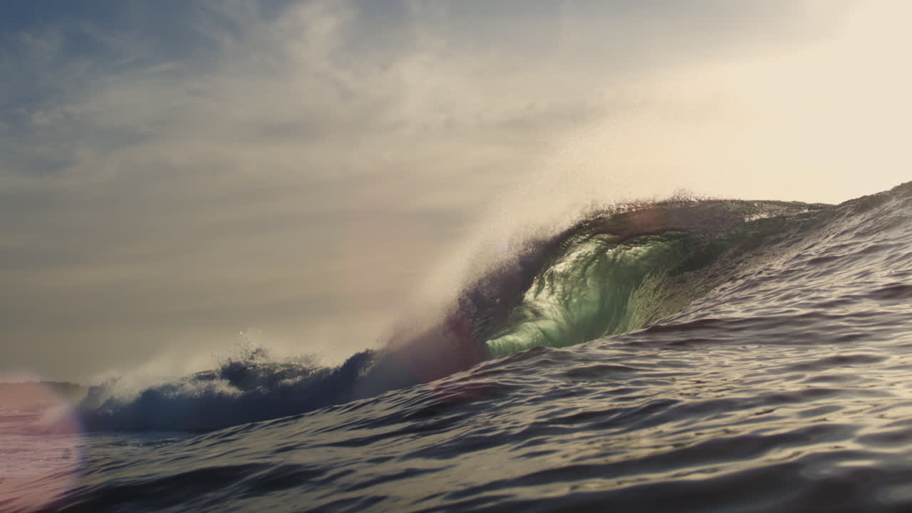 Slow Motion Ocean Wave Breaking with Sunlight and Spray