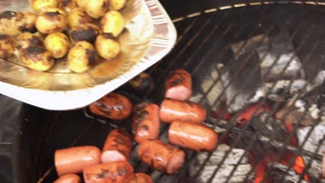 grilling sausages and potatoes