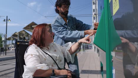 assisting a wheelchair user at a ticket machine