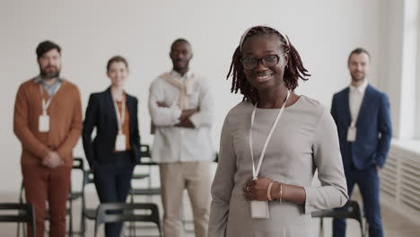 african office worker posing and smiling