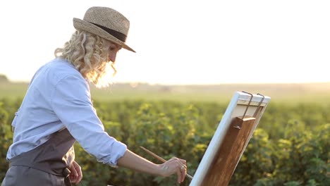 a professional artist paints a picture