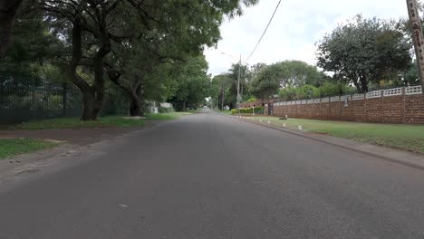 low-level drone shot of a street in a residential area of pretoria, south africa