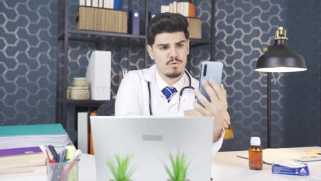 The-young-doctor-who-is-video-talking-on-the-phone-explains-the-medicine.