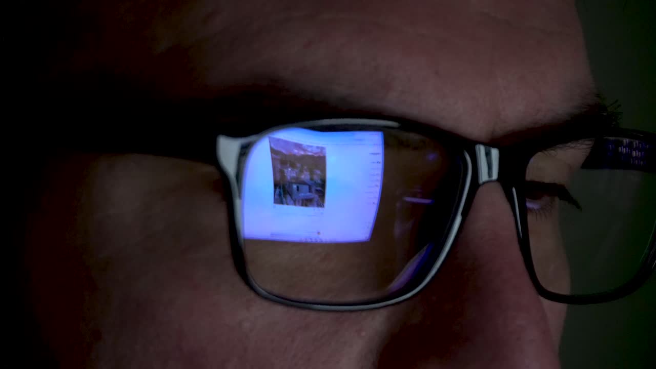 Screen Reflection on Glasses, Guy Working on Computer, Close up Shot