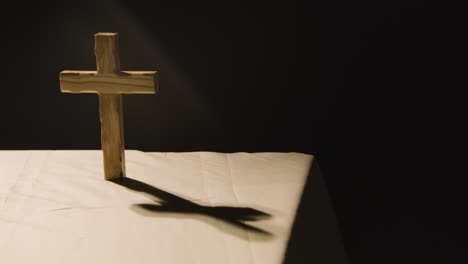 Religious-Concept-Shot-With-Wooden-Cross-On-Altar-In-Pool-Of-Light-2