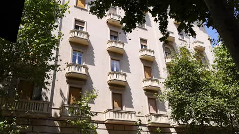 a building with balconies and trees