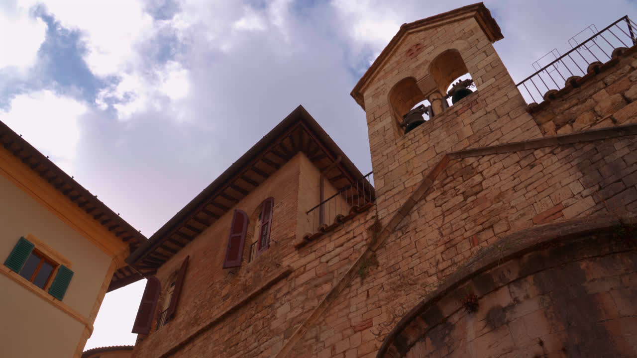 Brick tower and arched facade from historic building seen in old town Perugia