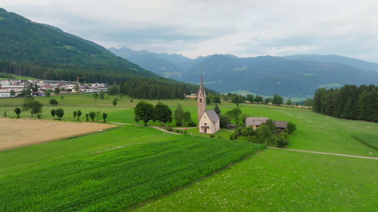 Slow orbit drone shot of St. Valentin church in Falzes village, Dolomites, Italy