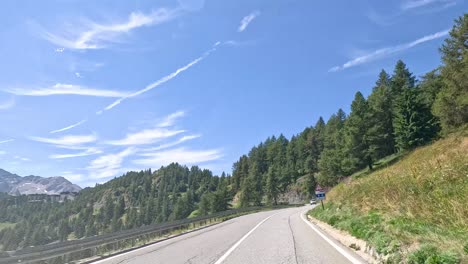 mountain road with lush greenery and clear skies