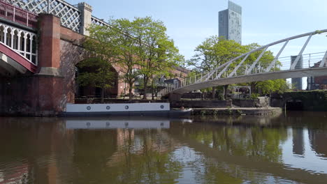 Tilt-Shot-Revealing-Manchester-City-Skyline-and-Beetham-Tower-with-Canada-Geese-and-Canal-in-Foreground-on-Sunny-Day