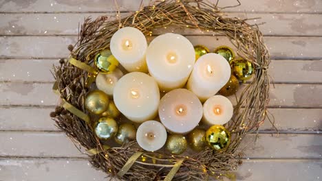 falling snow with christmas candles in wreath