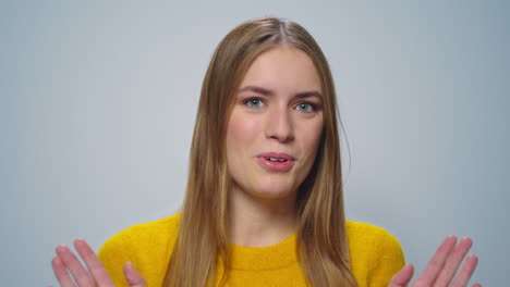 portrait of displeased woman gesturing stop sign with hands in studio.