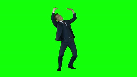 Businessman-lifting-something-on-green-screen-