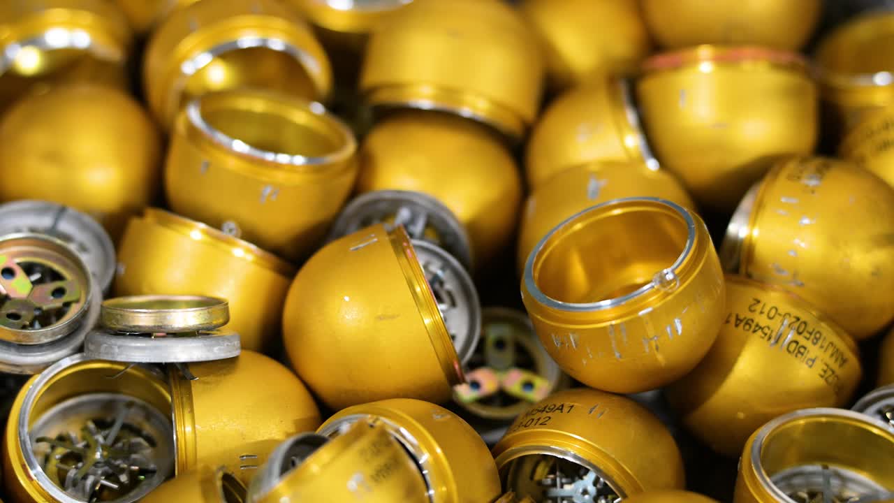 In Ukraine's Donetsk region, a workshop modifies grenade casings with plastic for drone deployment. Highlighting adaptive weapon tech for combat.