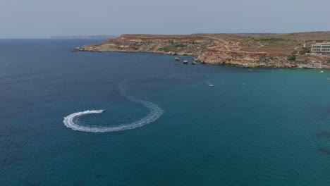 speedboat in high speed glides across the blue water of sea in malta