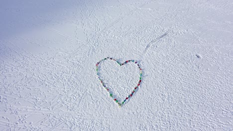 aerial top view heart shape on ice made by children, positive message it will get better - covid 19