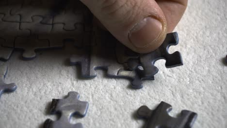 man builds a 1000 piece puzzle, close up shot 4k