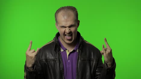 Rocker-man-showing-rock-and-roll-sign,-devil-horns-gesture,-looking-with-crazy-expression