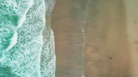 The-Beautiful-Scenery-Of-A-Calm-Waves-Splashing-In-The-White-Sand---Aerial-Shot