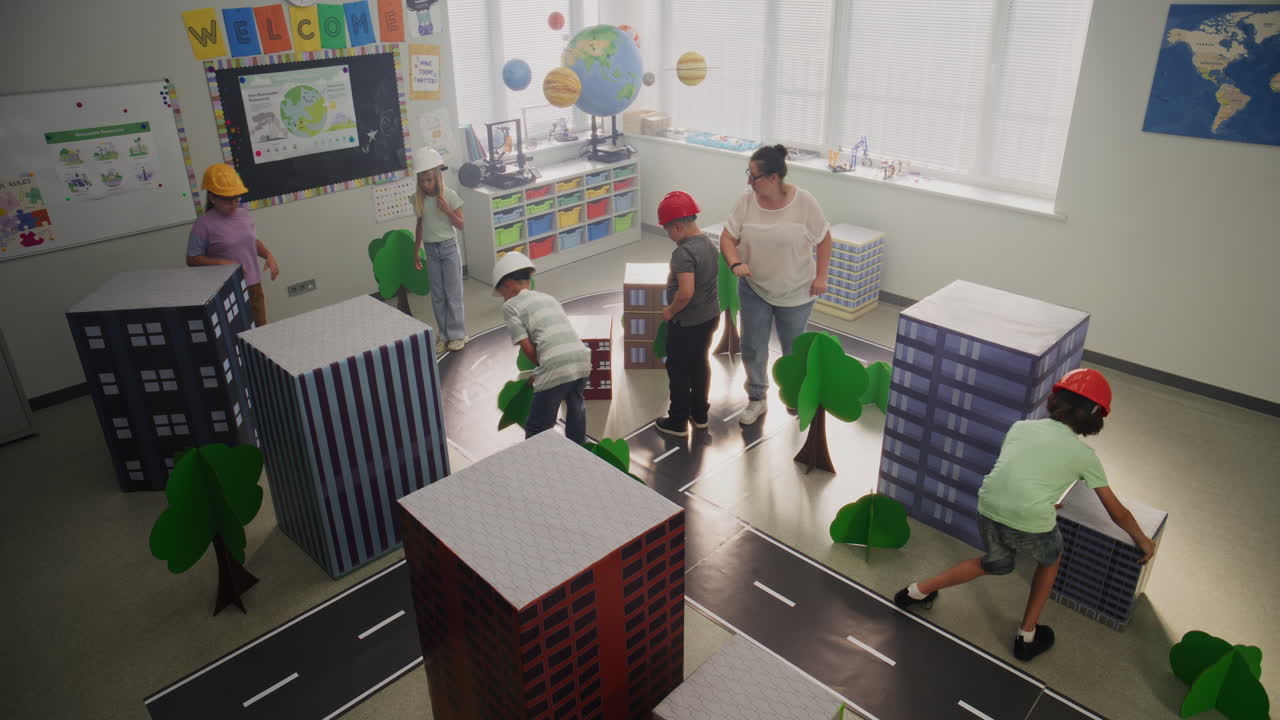 Team of Primary School Students in Hardhats Creating City Planning
