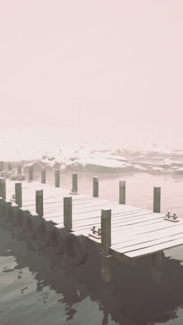serene wooden pier leading into misty winter waters