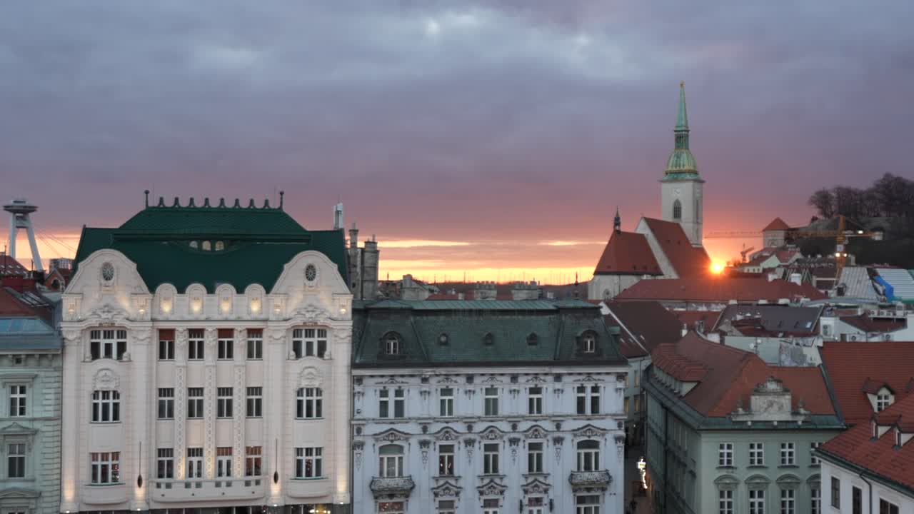 Sunset over the main square in Bratislava Old Town in Slovakia with the Bratislava castle in the background
